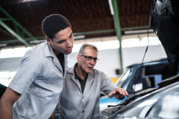 istock Auto mechanics analyzing the car engine on the repair shop 1464834285
