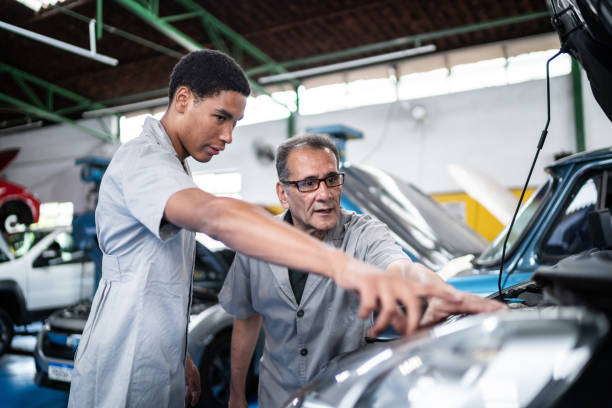 Auto mechanics analyzing the car engine on the repair shop