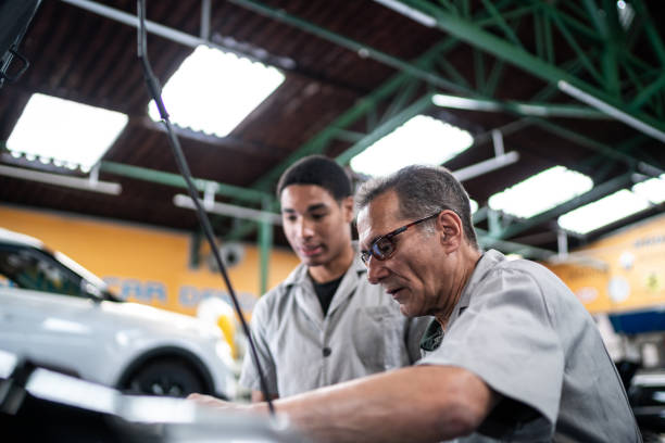 istock Auto mechanics analyzing the car engine on a repair shop 1464834304