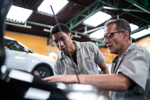 istock Auto mechanics analyzing the car engine on the repair shop 1464834323