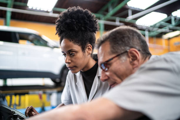 istock Auto mechanics analyzing the car engine on the repair shop 1464834398