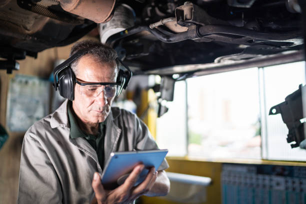 istock Auto mechanic man using digital tablet on a repair shop 1464836191