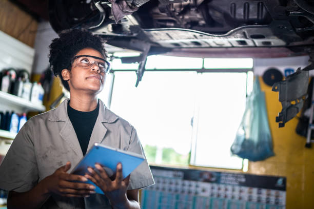 istock Auto mechanic woman analyzing the using digital tablet on a repair shop 1464836309