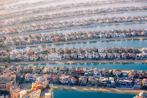 Dubai, UAE - August 28, 2022: The Palm Jumeirah. Holidays villas, beaches and luxury hotels view at sunset.