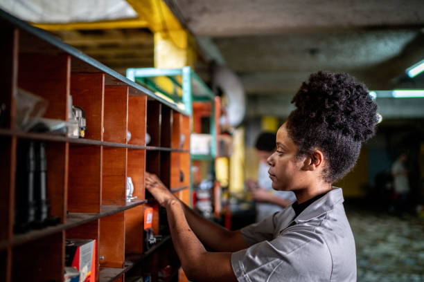 Auto mechanic woman organizing the shelf on a repair shop