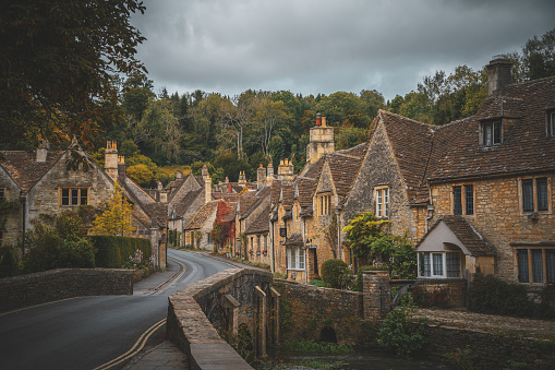 The landscape view of Castle Combe is a traditional Cotswold cottage with a river and bridge quintessentially English village often named the prettiest village in England. Castle Combe Wiltshire England. Natural Beauty in north west Wiltshire