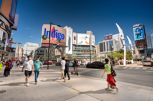 Toronto, Canada - August 16, 2021:  Yonge and Dundas Square in the city downtown centre is an outdoor public space and event venue surrounded by shopping malls, businesses and restaurants
