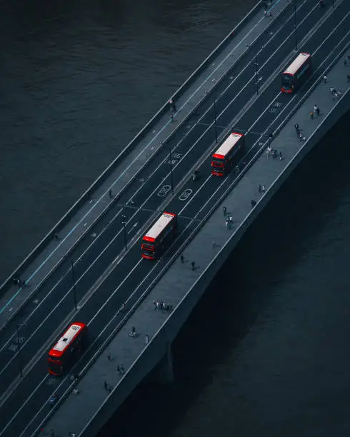 Photo of Aerial view of London Bridge and red double-decker buses in London, UK