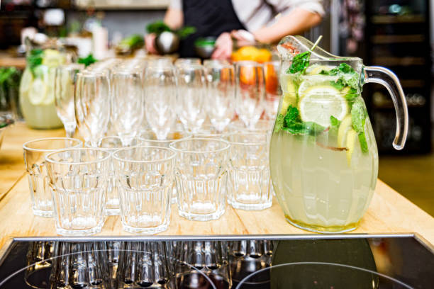 Citrus lemonade with lime, mint and ice on the bar counter stock photo