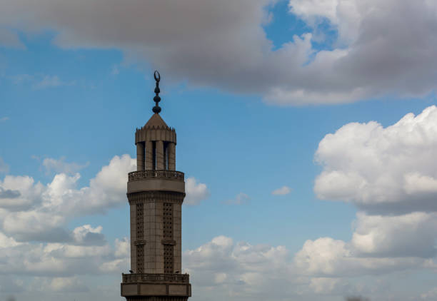 istock Old white mosque minaret with cloudy sky 1464845575