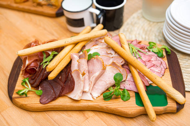 istock prosciutto breadsticks with variety cured meat on wooden board 1464846256