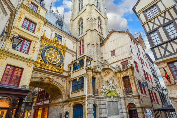 The gros horloge, the medieval astronomical clock on the main street Rue Du Gros Horloge in the medieval center of Rouen France. The gros horloge, the medieval astronomical clock on the main street Rue Du Gros Horloge in the medieval center of Rouen France. Rouen, capital of the northern French region of Normandy, is a port city on the river Seine. Important in the Roman era and Middle Ages, it has Gothic churches, such as Saint-Maclou and Saint-Ouen, and a cobblestoned pedestrian center with medieval half-timbered houses. rue du gros horloge photos stock pictures, royalty-free photos & images