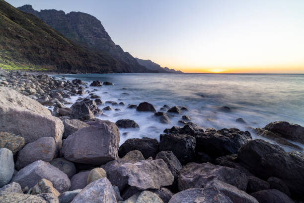 istock Rocks and Waves: A Majestic Sunset at the Beach 1464858970