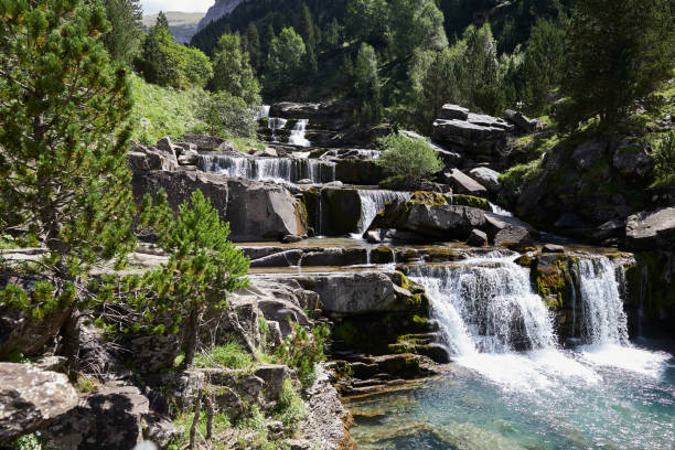 istock Waterfall in a landscape of rocks and vegetation 1464862648