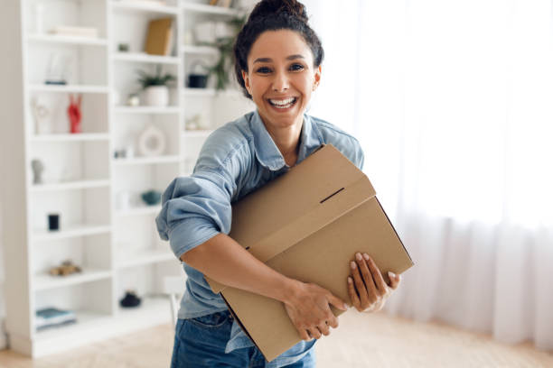 istock Happy Arabic Lady Customer Holding Cardboard Box Package At Home 1464865607