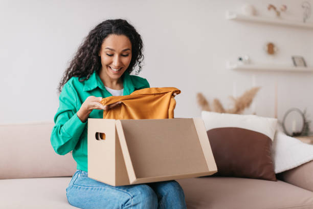 istock Excited Lady Customer Unpacking Received Parcel With Clothes At Home 1464867004