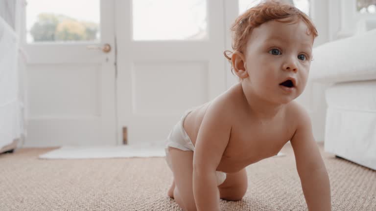 cute baby boy crawling toddler exploring with curiosity happy infant learning having fun enjoying childhood at home 4k