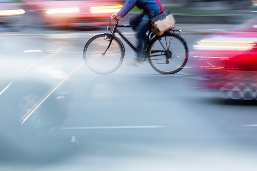 bicycle rider in city traffic with camera motion blur effect