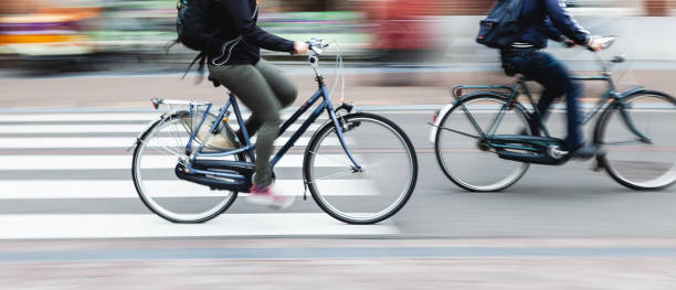 bicycle riders on a city street picture with camera made motion blur effect of bicycle riders on a city street bicycle stock pictures, royalty-free photos & images