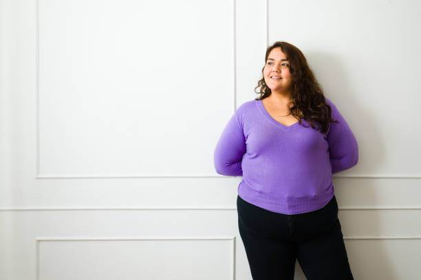 istock Thoughtful fat woman smiling next to copy space 1464879828