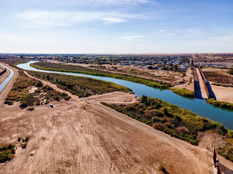 International Border Wall with Agricultural Fields, Canal and Colorado River Between Yuma, Arizona and Algodones Mexico with Water Diversion and Aquaduct Operation Conserving Scarce Water Resources