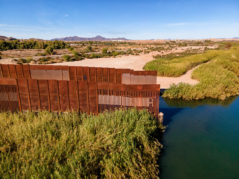 End of International Border Wall at Colorado River Near Algodones Mexico and Yuma Arizona with Agriculture and Desert in an Arid Climate