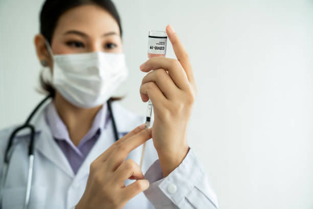 istock Skillful doctor prepare vaccine proficiently before injection . Covid 19 and coronavirus vaccination center service concept . 1464887920