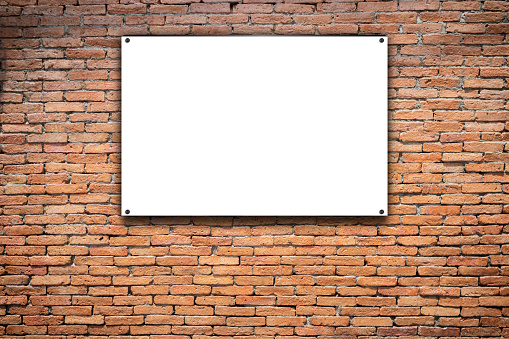 Blank white poster in black frame with copyspace for your text on brick wall outdoor. 3D rendering, mockup. Distressed red brick wall texture grunge background.