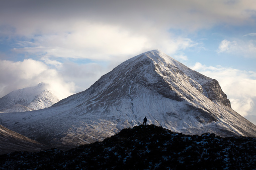 Distant figure against the backdrop of the Red Cuillin mountains in winter, Isle of Skye - Scotland