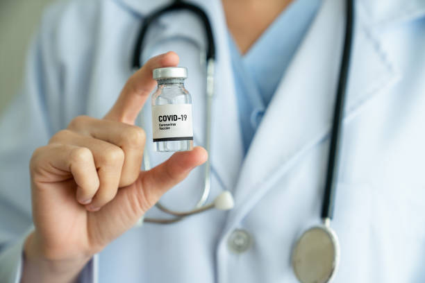 istock Skillful doctor prepare vaccine proficiently before injection . Covid 19 and coronavirus vaccination center service concept . 1464895309