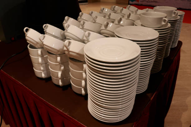 istock Stacks of plates and glasses on a table 1464896869