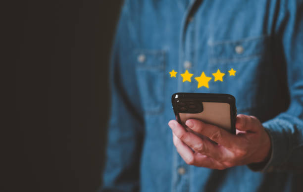 istock Selective focus at finger of business man while point finger to choose feedback on excellent customer service with five star score with smile. Service evaluation concept with futuristic icon. 1464901564