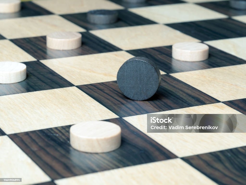 Checkers Backside Black Checker Standing On Its Side Surrounded By White Checkers On A ...