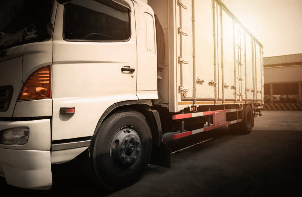 istock Cargo Container Trucks Parked at Warehouse. Commercial  Delivery Trucks. Distribution Warehouse. Shipping Freight Truck Logistics Cargo Transport 1464912129