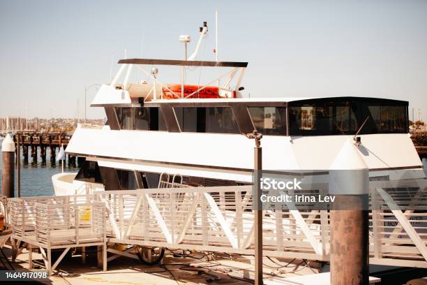 Close Up Of White Cruise Boat Parked In Matina City With Bay Views And Small Cruise Ships Stock Photo - Download Image Now