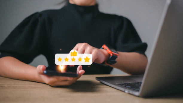 istock Hand pressing on smartphone screen with gold five star rating feedback icon and press level excellent rank for giving best score point to review the service , business concept 1464923193