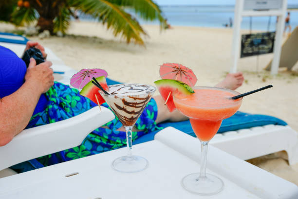 Happy mid adult woman enjoying in her cold summer drink.