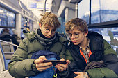 Teenagers travelling on modern train