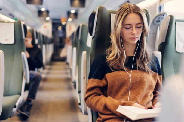 Teenage girl travelling on modern train