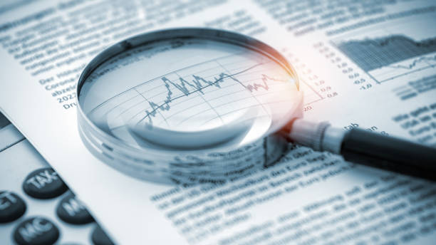 istock Magnifying glass on financial chart 1464935947