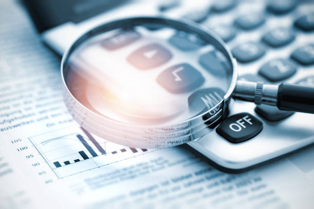 istock Magnifying glass on financial chart 1464935989