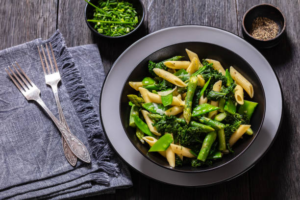 istock Pasta primavera with green veggies, cheese in bowl 1464936143