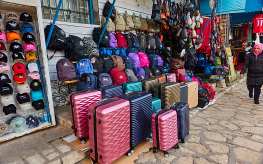 Sousse, Tunisia, January 7, 2023: Sales stand in the souk with suitcases and rucksacks, some of which have counterfeit trademarks