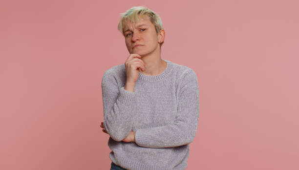 istock Thoughtful clever woman pondering a solution, doubting question, rubbing chin, pensive expression 1464943877