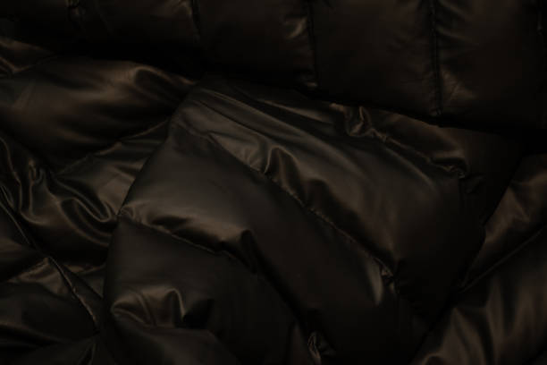 istock black down jacket winter puffed as a background close up 1464948178