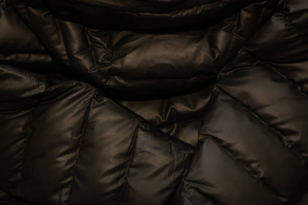 istock black down jacket winter puffed as a background close up 1464948216