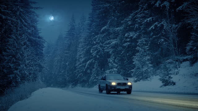 Mountain Highway On Snowy Evening With Passing Cars