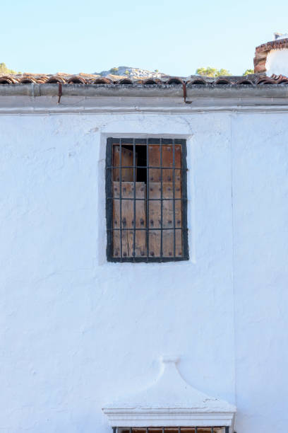 istock Fenced window of a building with curtains on the other side 1464952079