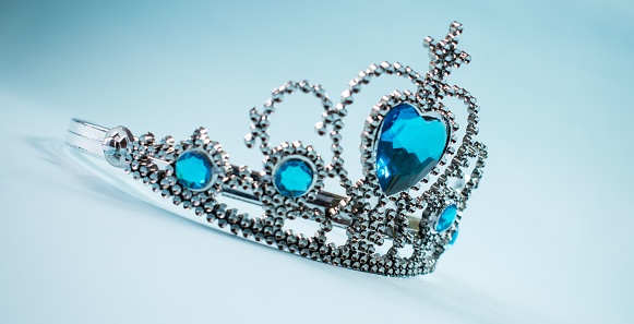 A silver crown with blue stones