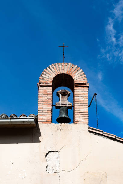 Bell in the arch of a hermitage against the blue sky A bell in the arch of a hermitage against the blue sky Laon stock pictures, royalty-free photos & images